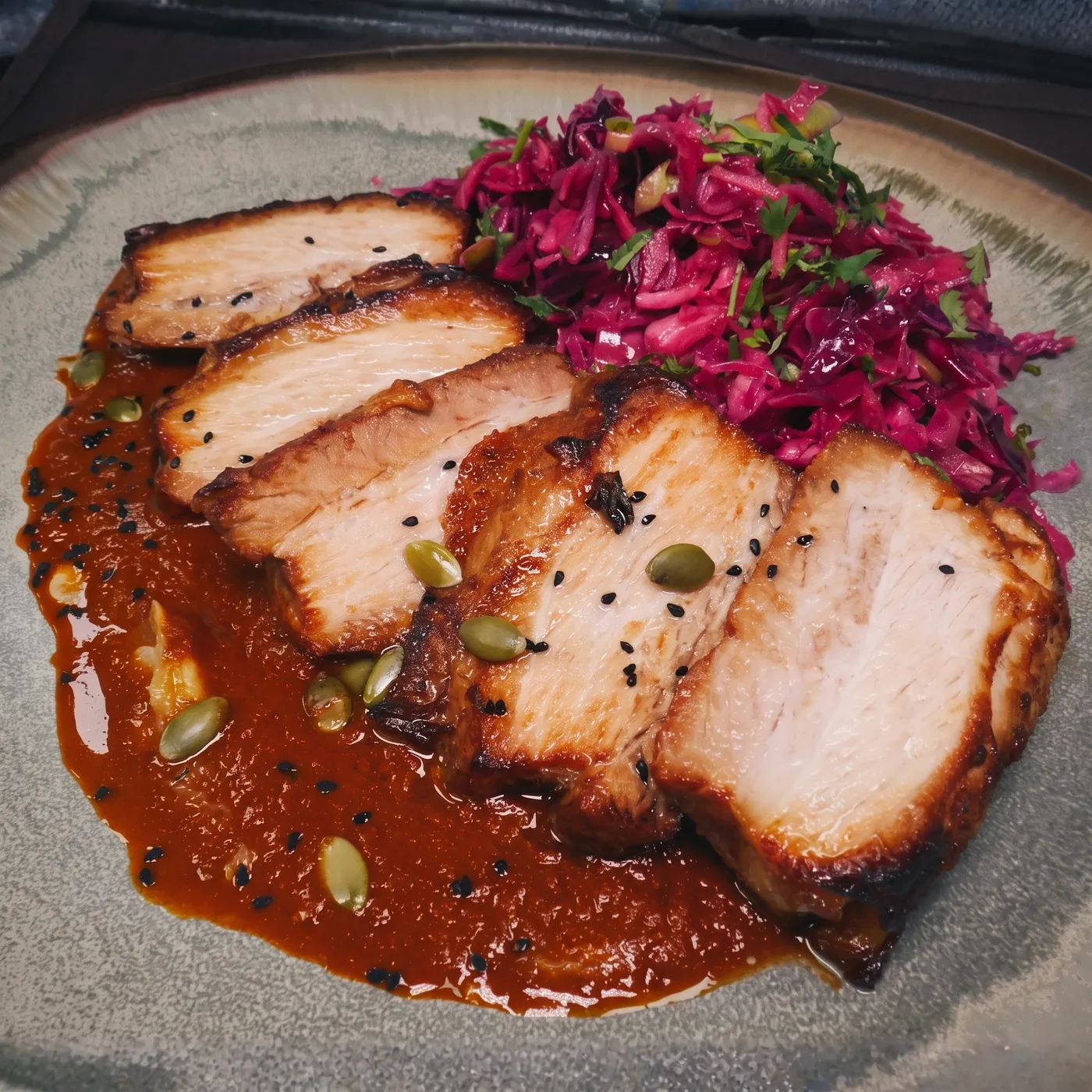 Sliced lacquered pork belly with black sesame mole, pickled red cabbage, and pumpkin seeds — Casa Tequila Prime